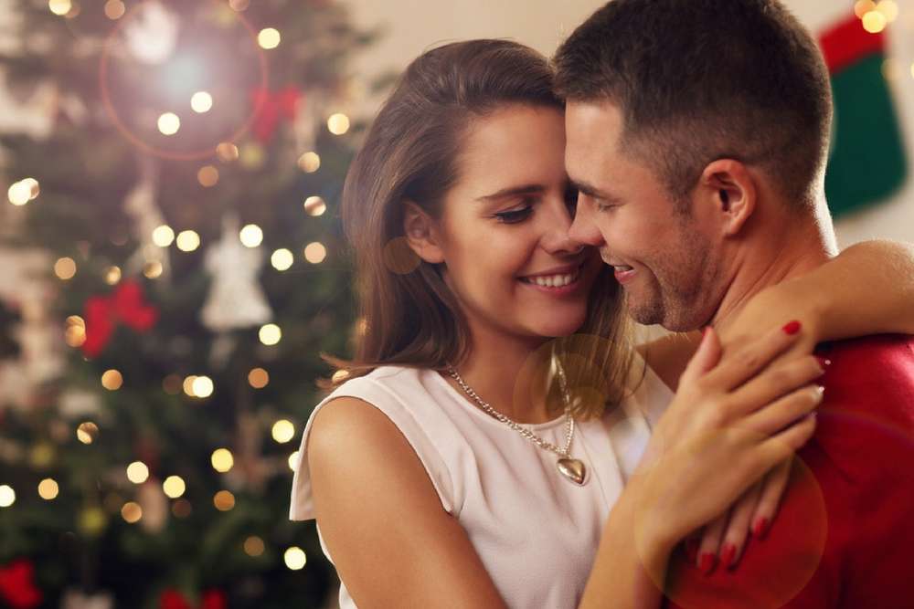 anaheimlighthouse-article-picture-of-young-couple-hugging-in-christmas-time-507204256-1