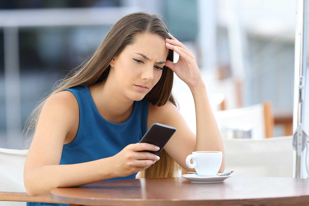 anaheimlighthous-how-can-i-handle-high-anxiety-without-drinking-article-photo-single-worried-woman-watching-a-mobile-phone-and-waiting-for-a-call-or-message-sitting-in-a-coffee-708178843