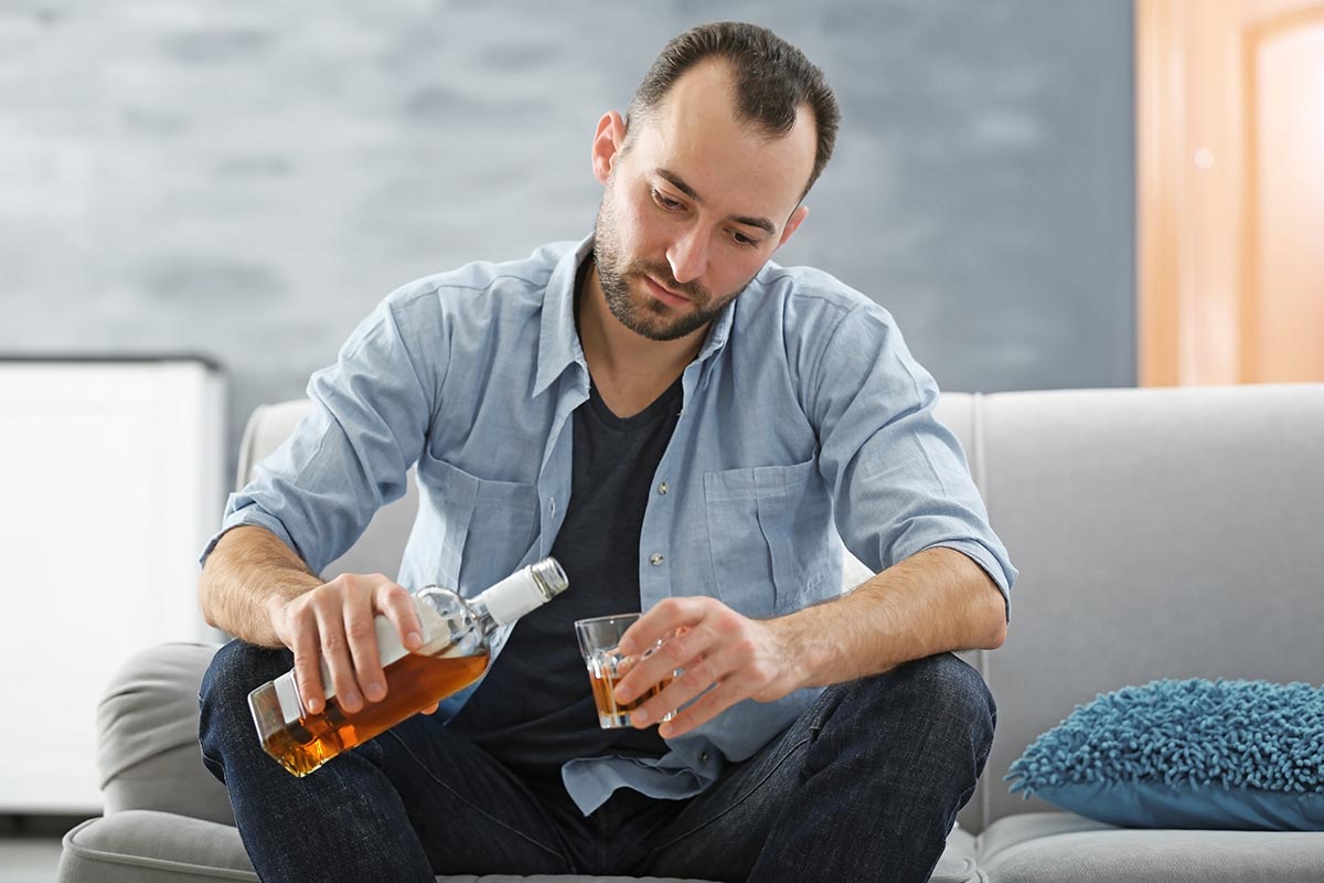 anaheimlighthouse-8-questions-non-alcoholics-dont-ask-themselves-article-stock-handsome-depressed-man-drinking-whisky-at-home-585761300