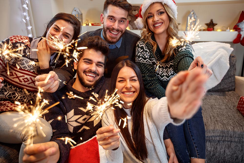 anaheimlighthouse-7-tips-to-stay-sober-on-new-years-eve-article-photo-cheerful-group-of-people-with-sparkles-together-celebrating-new-year-eve-725350819