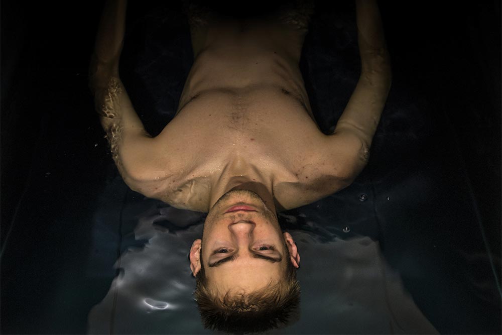 anaheimlighthouse-flotation-tank-therapy-in-addiction-treatment-article-photo-man-floating-in-a-sensory-deprivation-isolation-tank-filled-with-dense-salt-water-used-in-168930791
