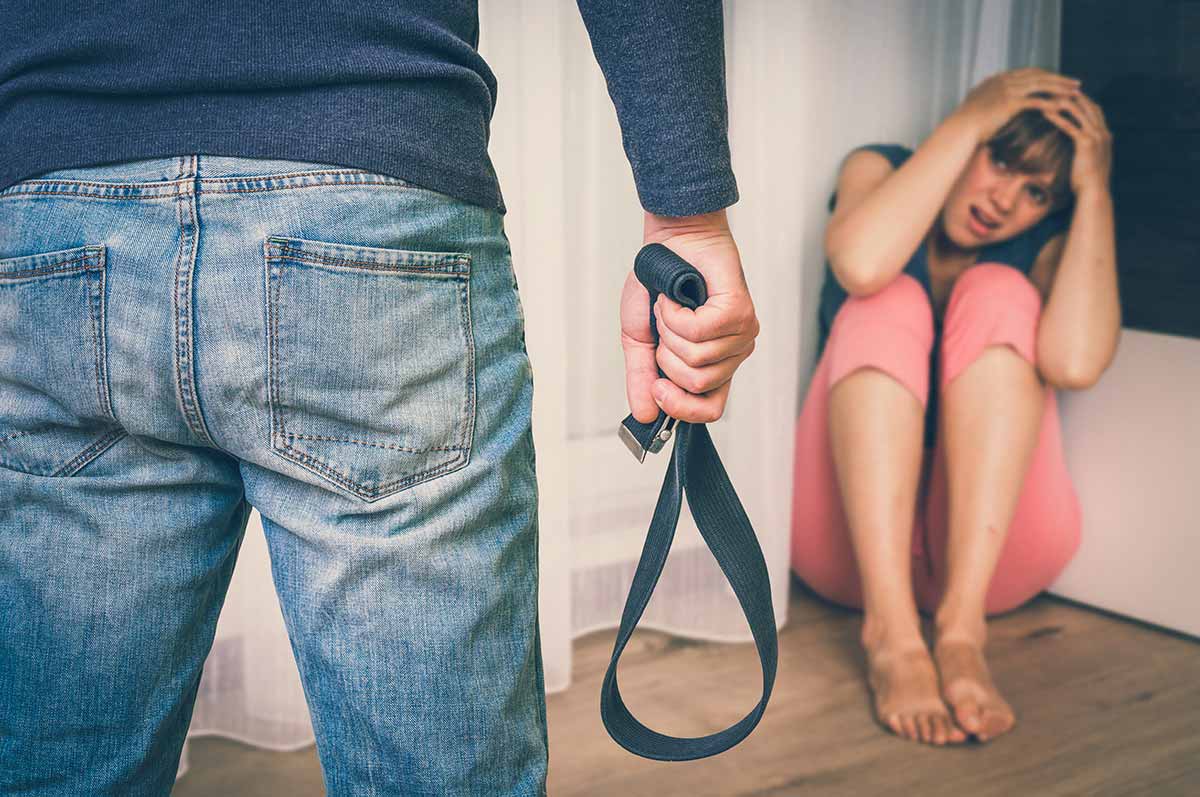 anaheimlighthouse-why-do-people-stay-in-abusive-relationships-article-photo-aggressive-man-with-a-belt-beating-his-wife-domestic-violence-concept-retro-style-1028052019