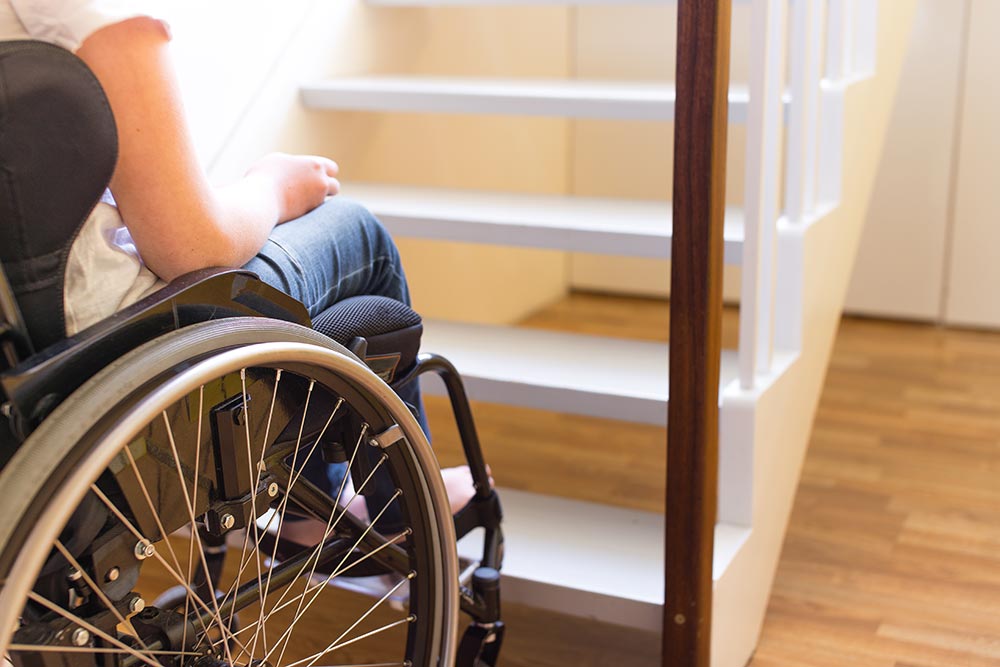 anaheimlighthouse-drug-and-alcohol-rehab-for-individuals-with-disabilities-article-photo-young-person-in-a-wheelchair-in-front-of-a-stair-678059302