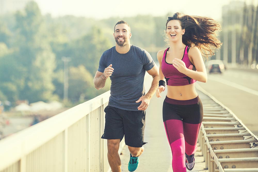 anaheimlighthouse-how-to-boost-your-self-esteem-after-rehab-photo-happy-couple-running-over-the-bridge-living-healthy-lifestyle