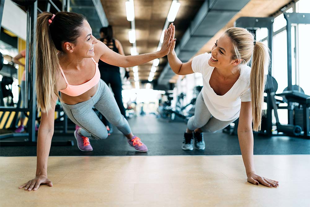anaheimlighthouse-8-ways-to-teach-yourself-you-deserve-love-in-recovery-article-photo-two-attractive-fitness-girls-doing-push-ups