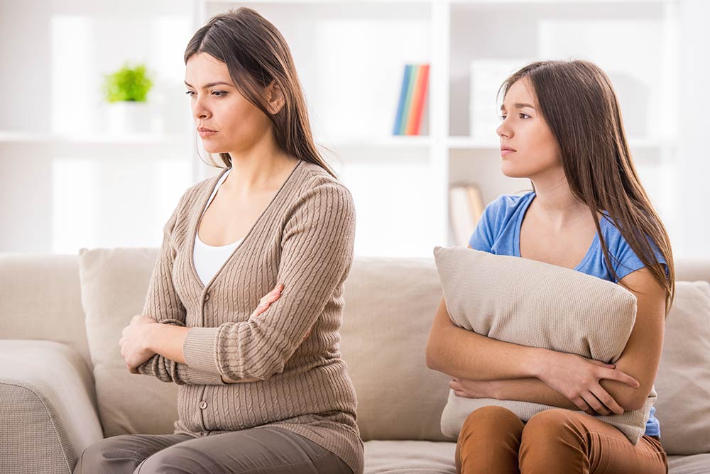 anaheimlighthouse-setting-healthy-boundaries-with-an-addict-article-photo-mother-and-teen-daughter-after-disagreement-on-sofa-at-home