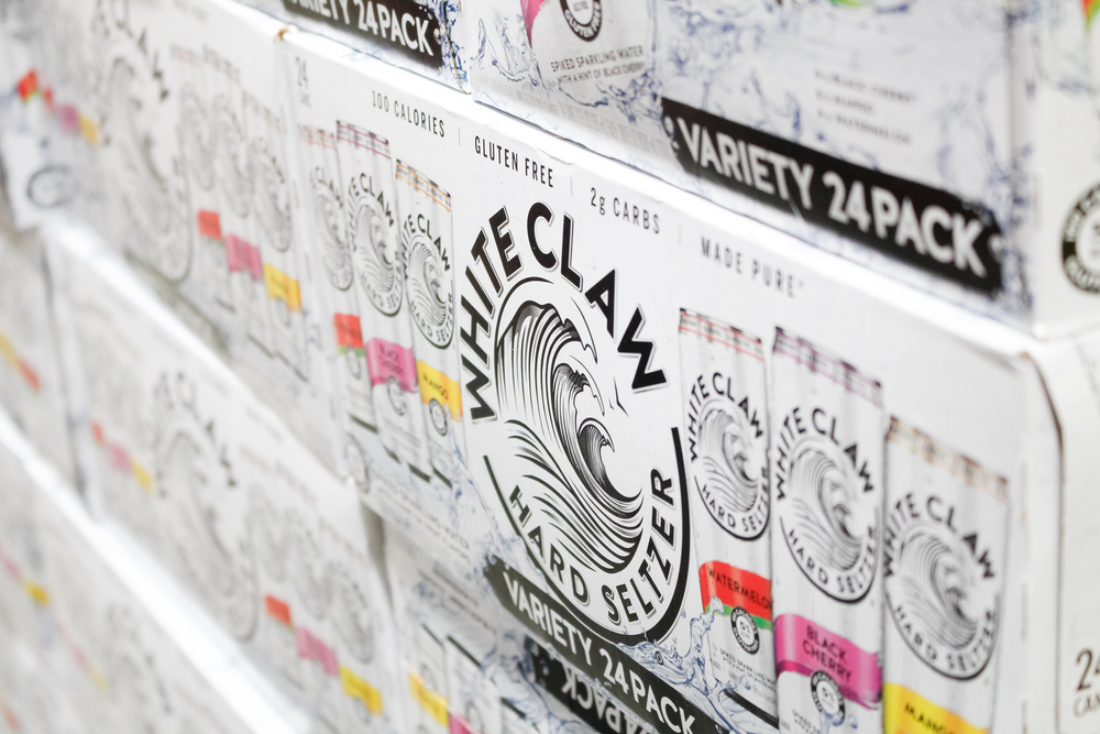Various flavor of White Claw boxes displayed in a shelves