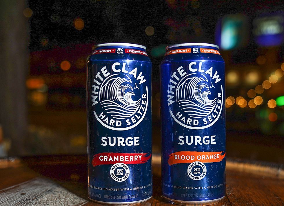 Two cans of White Claw Surge Hard Seltzer Cranberry and Blood Orange flavor
