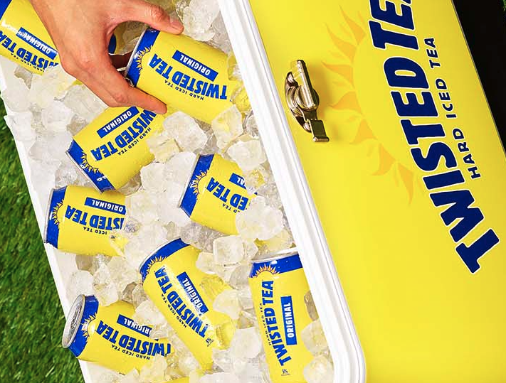 Man getting a can of Twisted Tea from an ice box cooler 