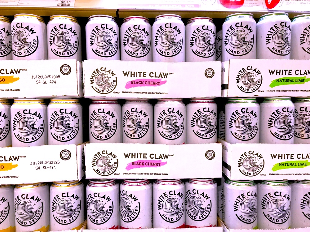 Rows of White Claw hard seltzer on grocery shelves