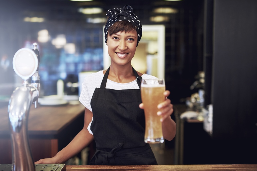 Waitress holding out draft beer