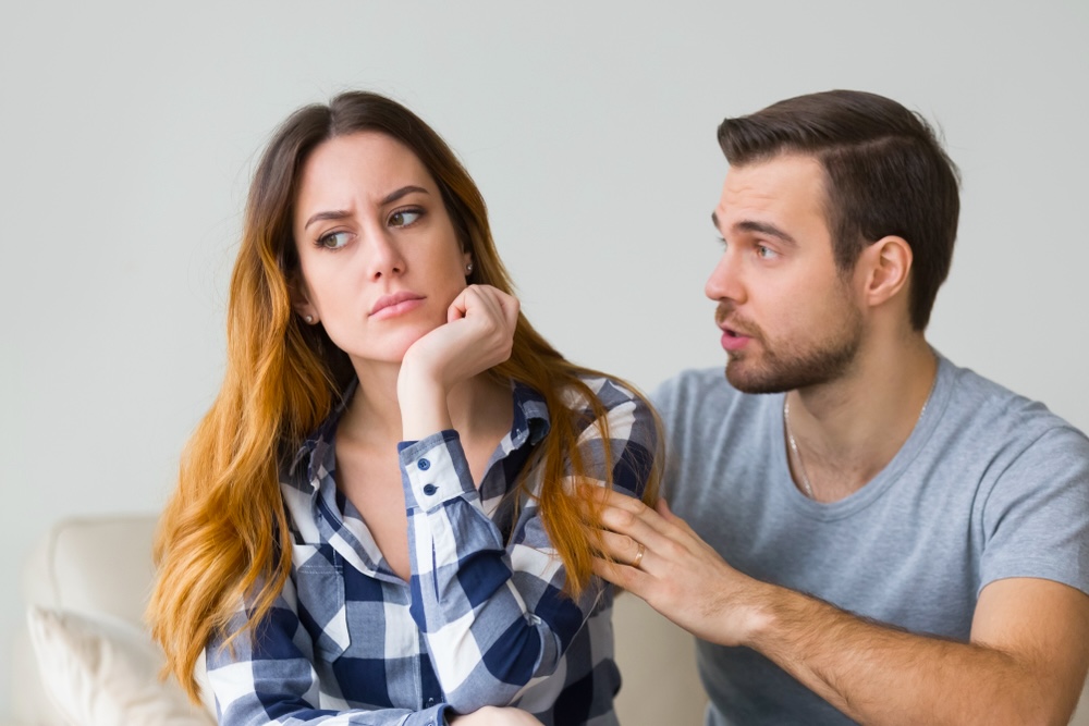 Wife looking away as husband tries to convince her