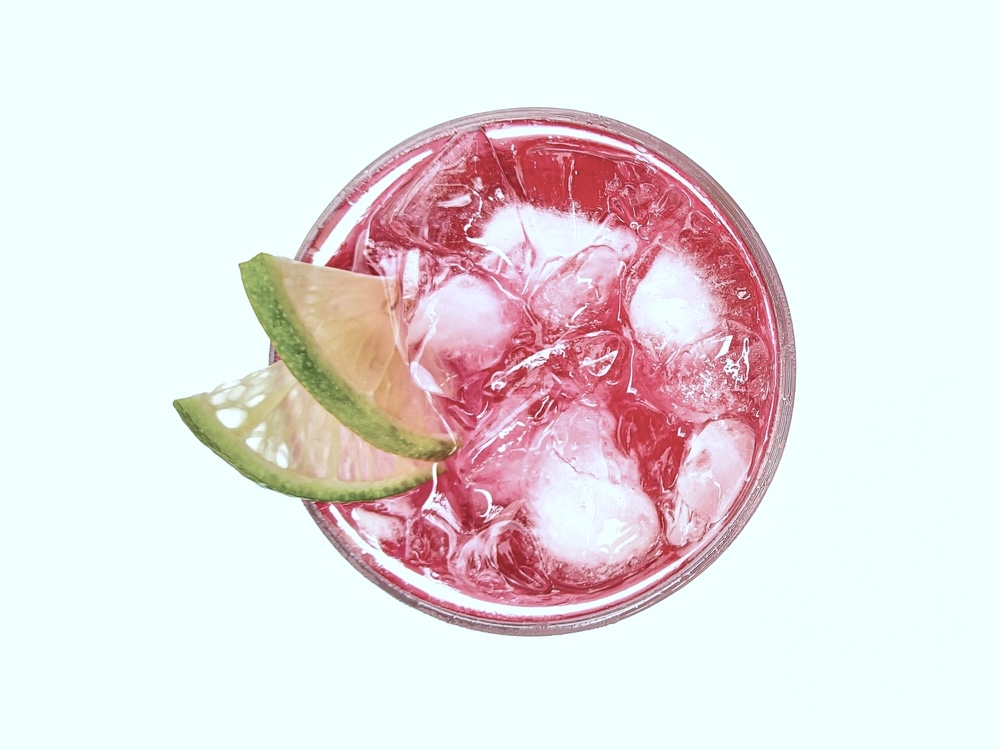 Top view of a glass of Pink Whitney isolated on white background.