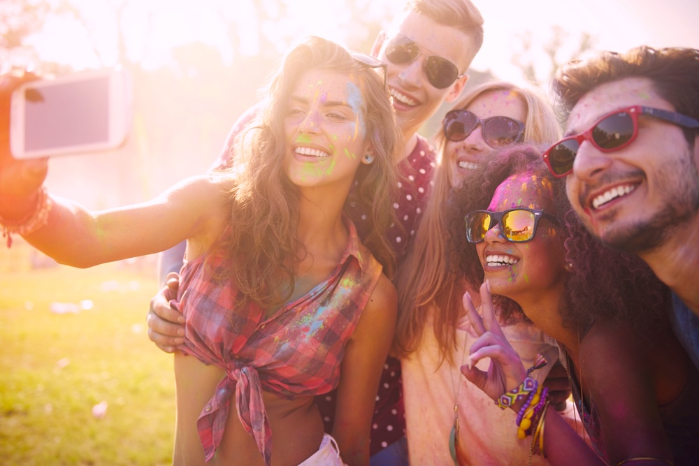 Young group taking a selfie at a summer festival