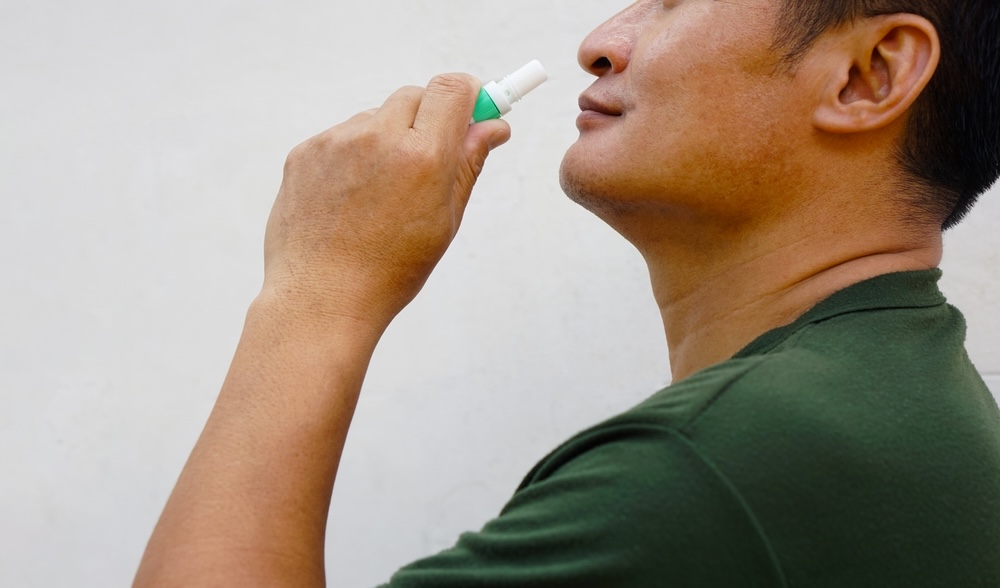 Man smelling aromatherapy inhaler to relieve anxiety