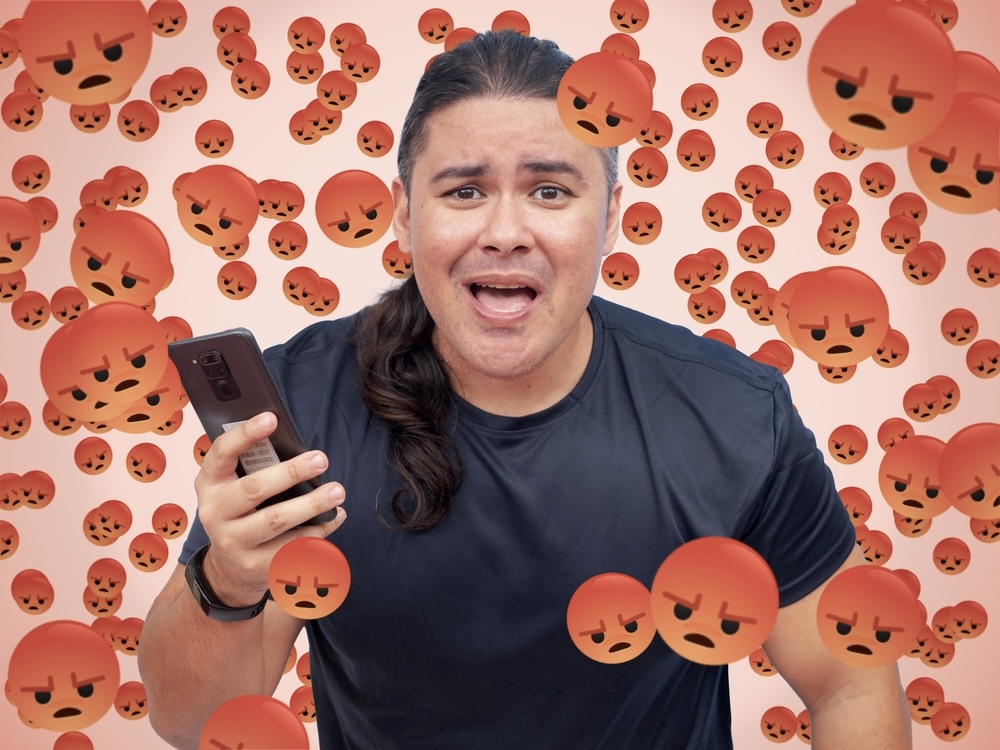 Man on social media is distressed and surrounded by angry emojis