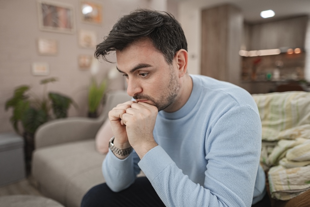 Man sitting looking at blank space while struggling with mental and emotional effects of cocaine 