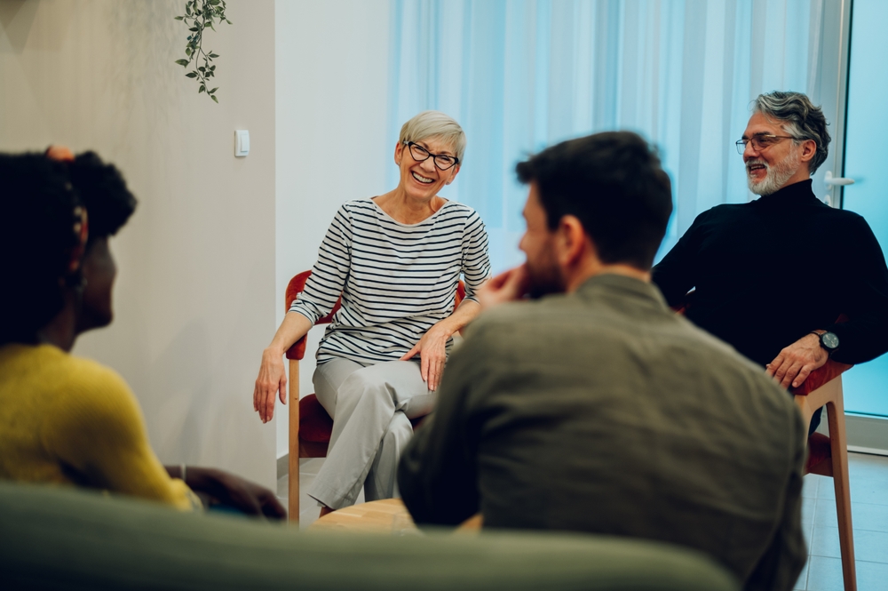 Woman looking upset talking to a therapist for drug addiction 