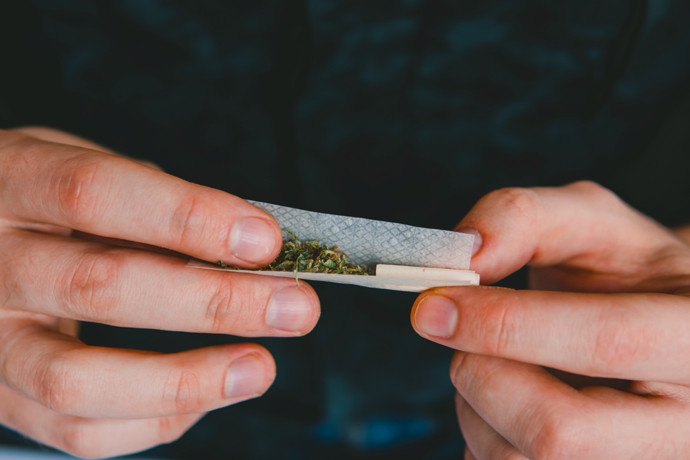 Man rolling a marijuana joint California sober 