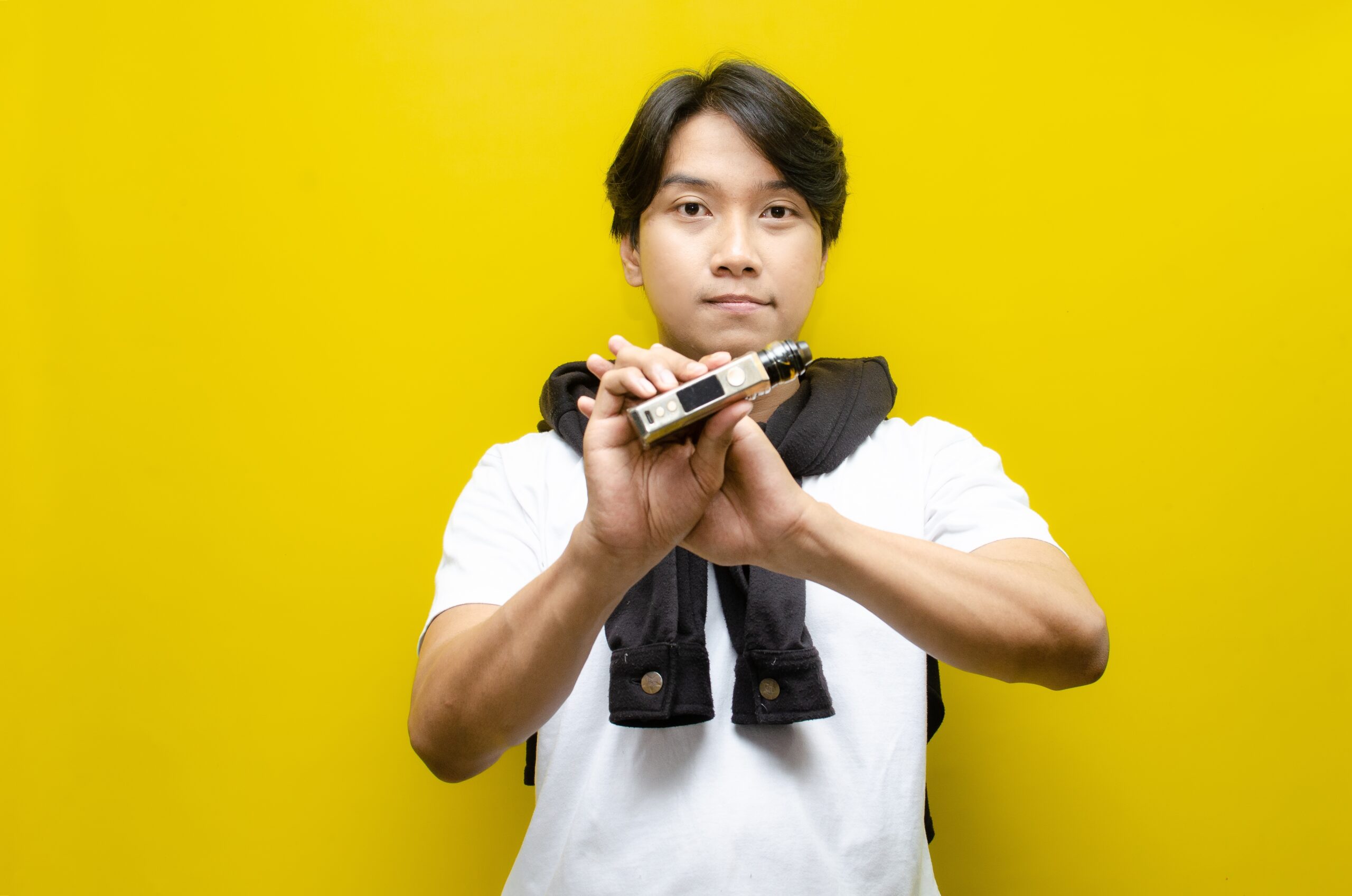 Man holding a vaping device wondering if you can get high off vapes