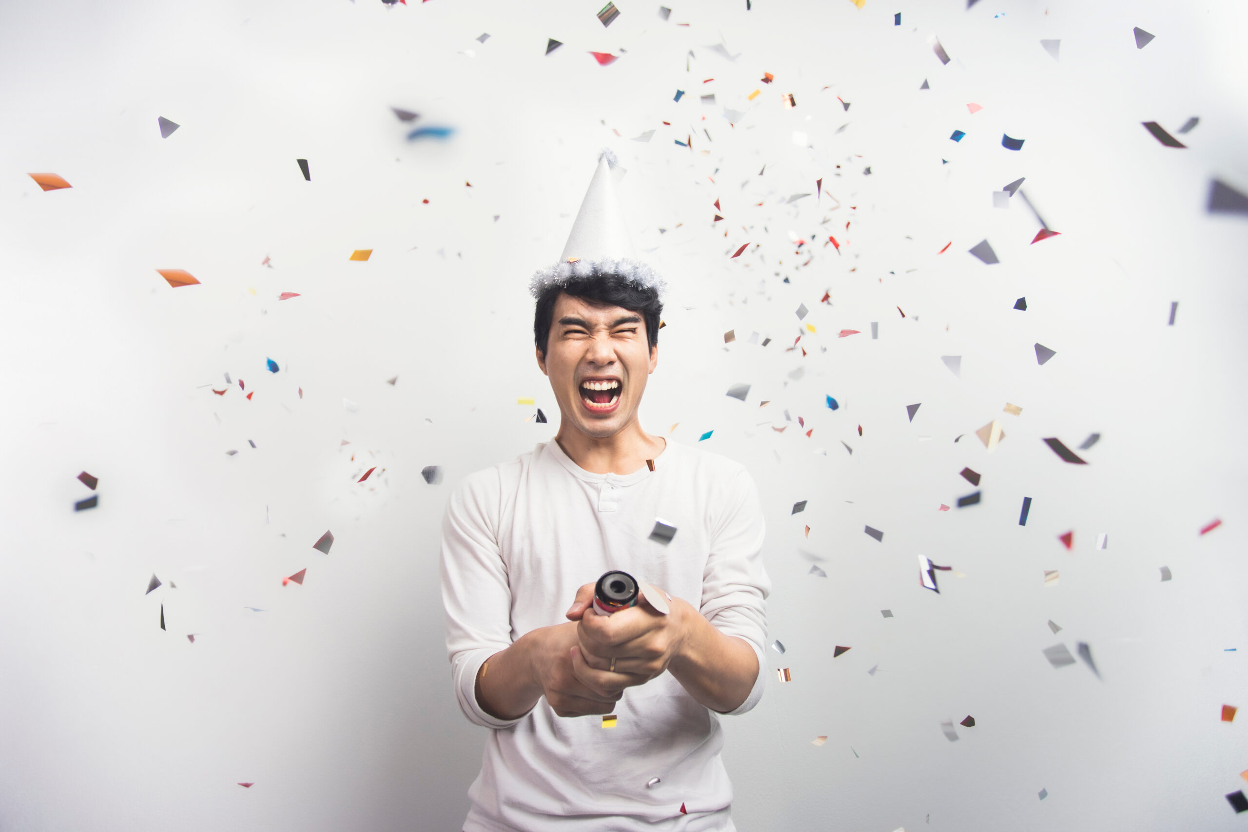 Man celebrating the new year sober with confetti popper