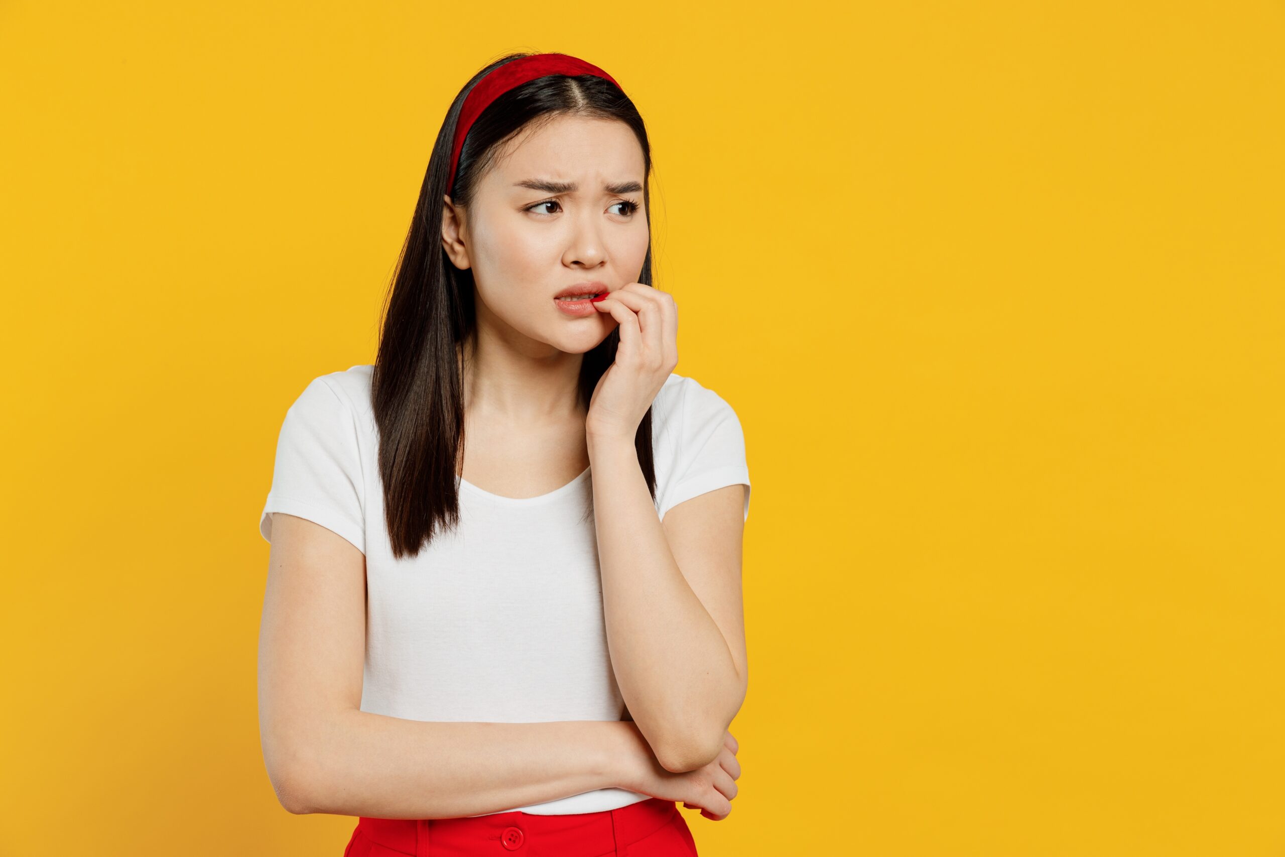 Woman biting her nails worrying about relapsing during the New Year