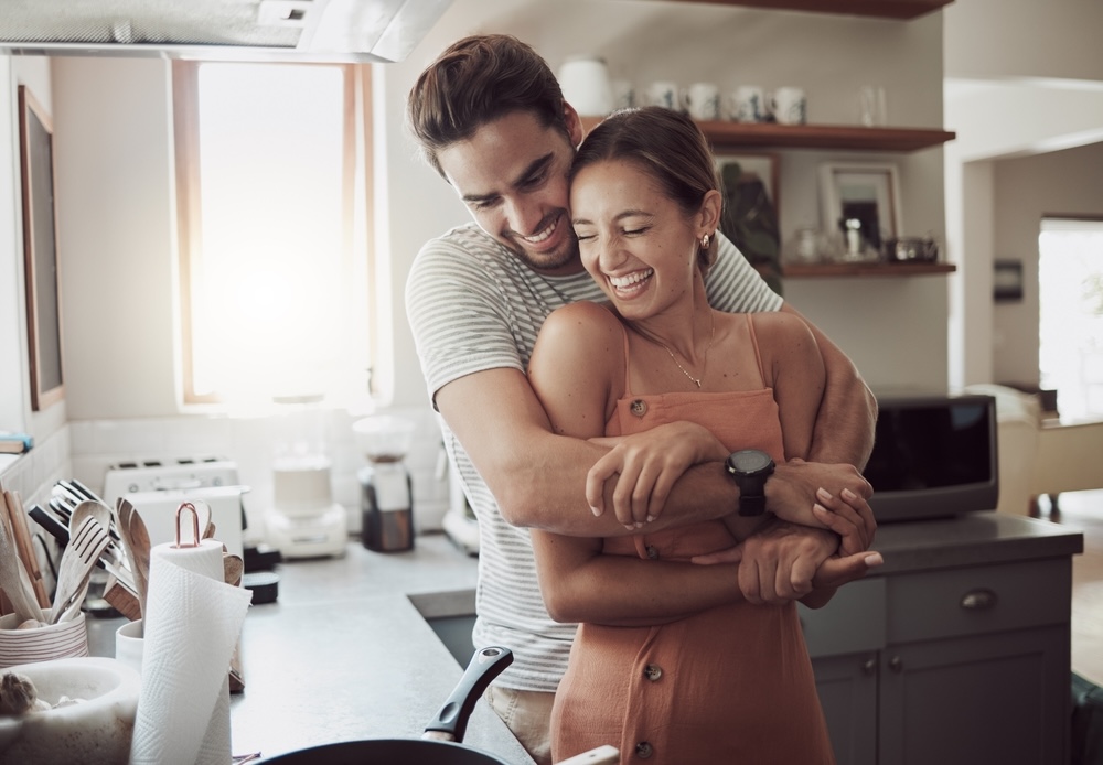 Man in addiction recovery falls in love hugs her in the kitchen 