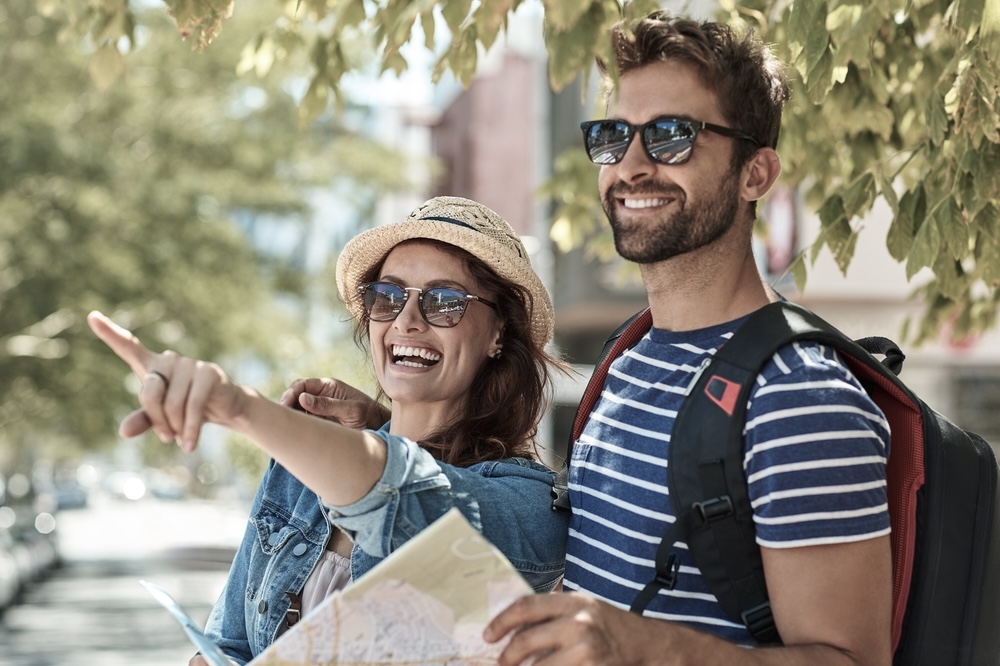 Couple on vacation sightseeing planning activities to avoid relapse triggers